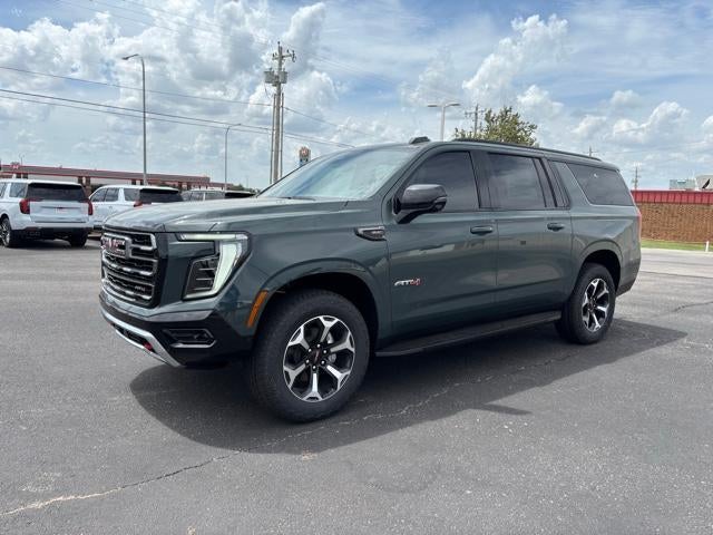 2026 GMC Yukon XL AT4 in Midnight Pine — front three-quarter view